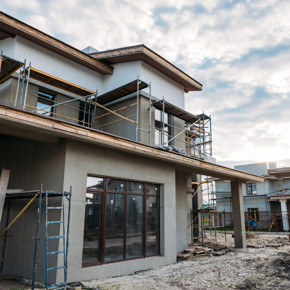 close-up shot of contemporary building construction with scaffolding under cloudy sky